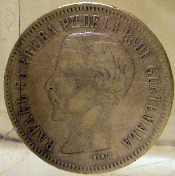 Moneda plateada con el perfil de Rafael Carrera y la leyenda Presidente de la República de Guatemala