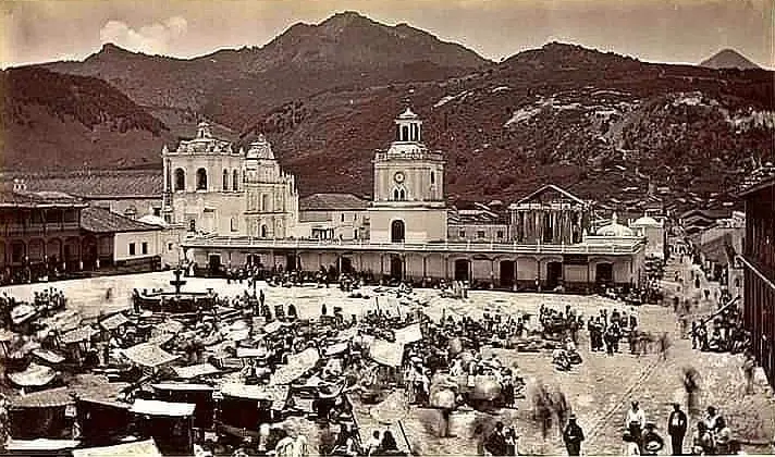 Vista de la plaza de Quetzaltenango en 1875, con edificios bajos y árboles