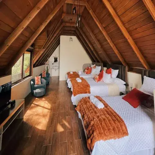 Interior de una cabaña familiar de Hacienda del Carmen con camas de madera